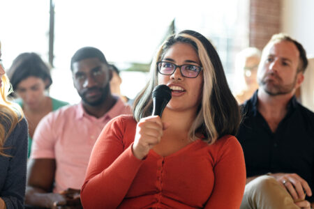 Closeup of a woman speaking on a microphone